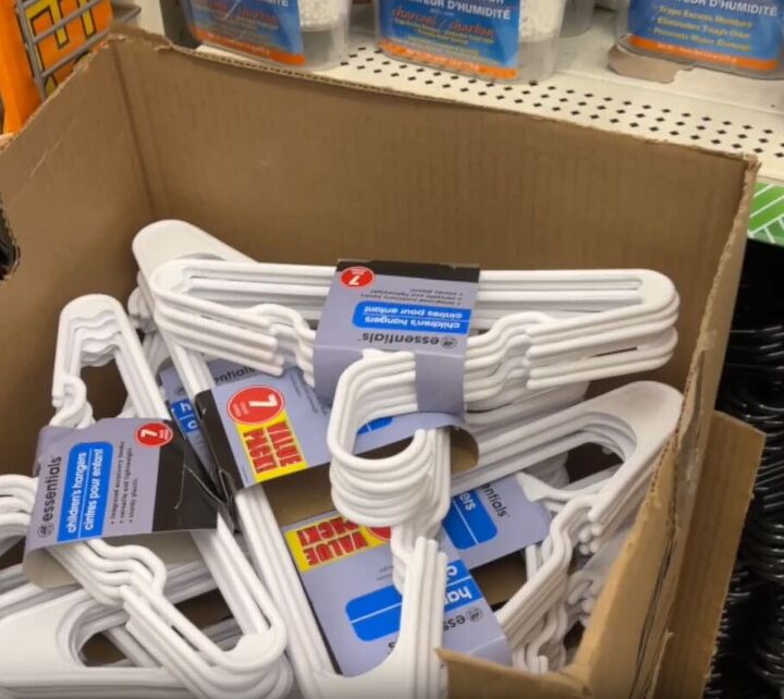 12 amazing hanger hacks to keep your home organized, A pile of new plastic white hangers in a cardboard box