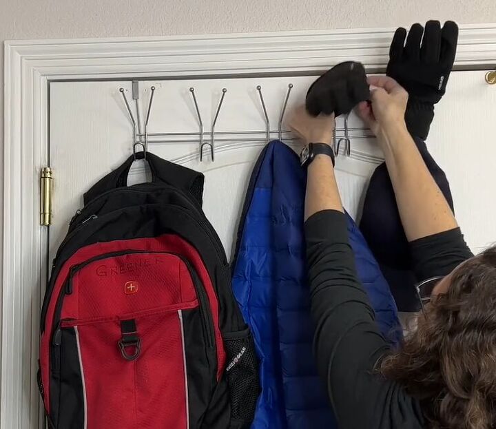 coat closet organization how to organize yours like a pro, Placing wet gloves onto the top of an over the door coat rack to allow them to air dry