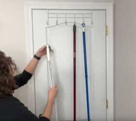 coat closet organization how to organize yours like a pro, Hanging brooms and dusters on an over the door rack