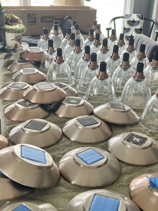 the best way to restore outdoor solar pathway lights, Bunches of glass globes and light covers lined up in an organized assembly line in order to spray paint them