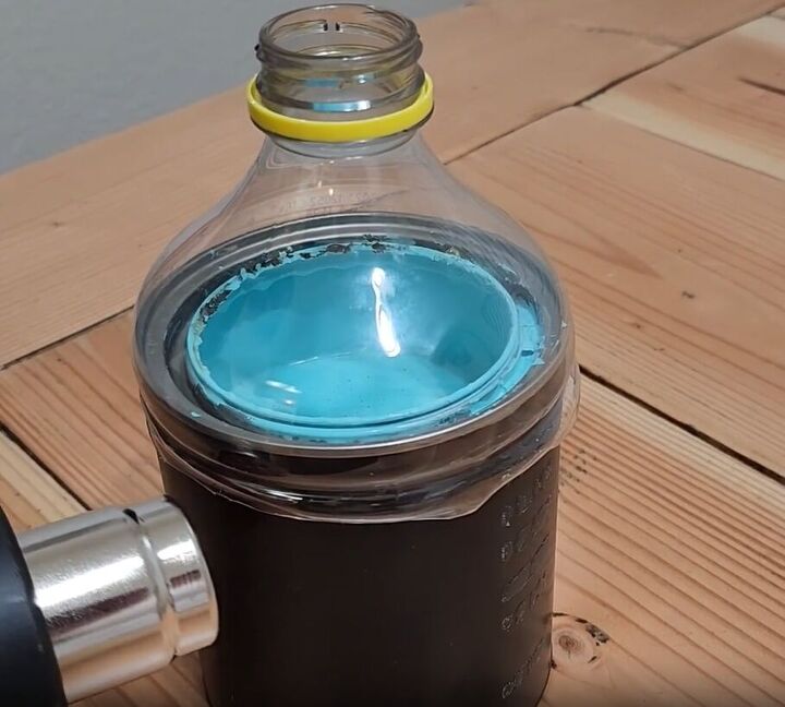 handyman tips 8 home improvement hacks to make your life easier, Molding a plastic bottle lid to the top of a paint can with a heat gun
