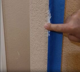 handyman tips 8 home improvement hacks to make your life easier, Applying caulk along the wall using the painter s tape as a guide