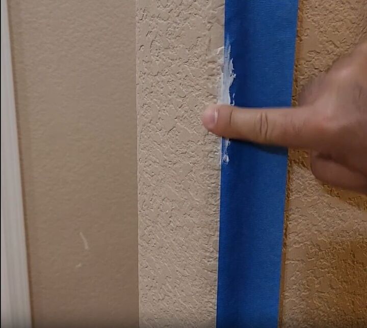 handyman tips 8 home improvement hacks to make your life easier, Applying caulk along the wall using the painter s tape as a guide