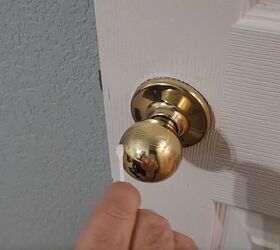 handyman tips 8 home improvement hacks to make your life easier, Spreading Vaseline onto a door handle with a Q tip