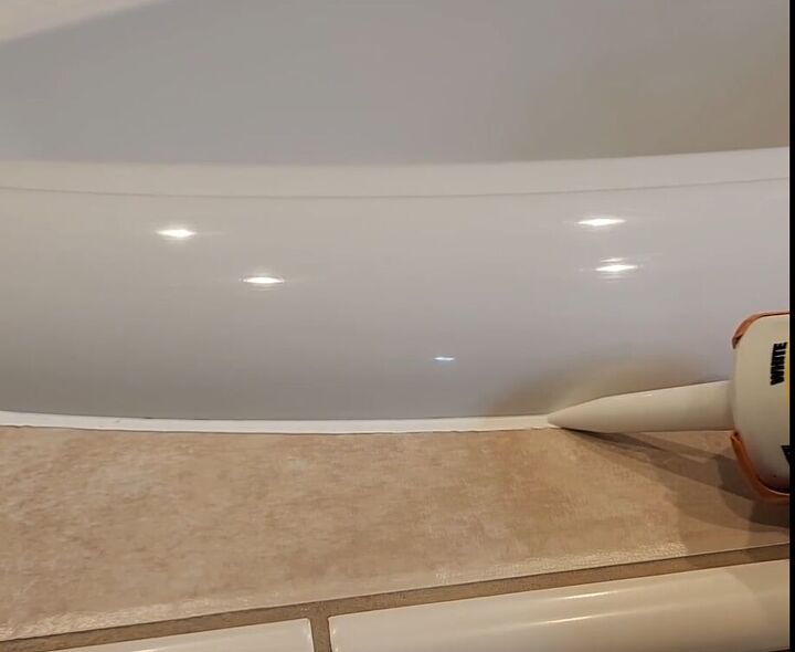 handyman tips 8 home improvement hacks to make your life easier, Applying caulk to a tub with a caulk gun