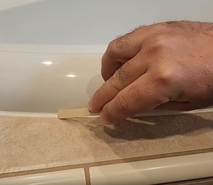 handyman tips 8 home improvement hacks to make your life easier, Using a popsicle stick to get a perfectly curved caulk line