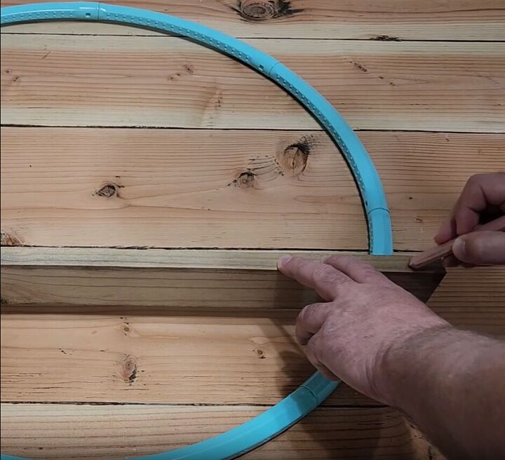 how to make a hula hoop shelf a cute family command center, Use a hula hoop to measure where you need to cut your boards