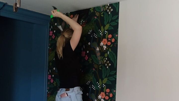 Trimming the wallpaper with a knife