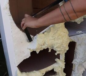 Cutting off the excess foam with a hand saw