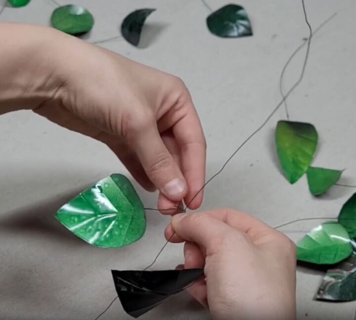 Twist larger leaves onto the top portion of the floral wire