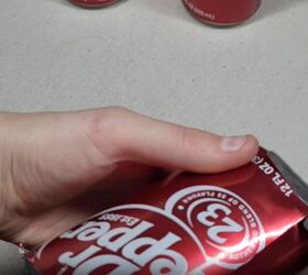 Trim off the bottom of the soda can with scissors