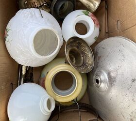 She brings a box of random lamp pieces onto her lawn for this beautiful garden accent