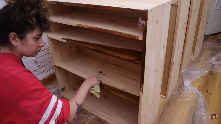 Staining the cabinets with wood stain