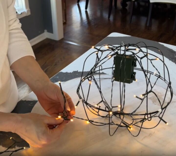 LED lights wrapped around the garden globe light, creating a spiral pattern