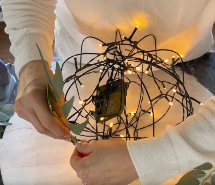 Leafy garland being attached to the orb light