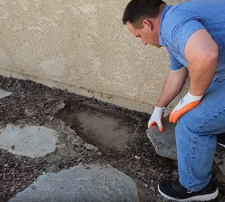 Clearing the ground of rocks for the cinder block bar and planter stand