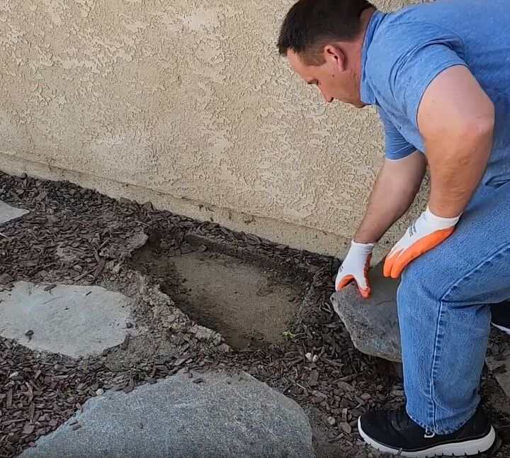 Clearing the ground of rocks for the cinder block bar and planter stand