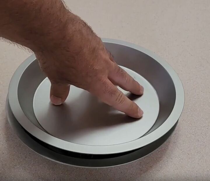 Smaller cake pan placed on marbles for DIY turntable