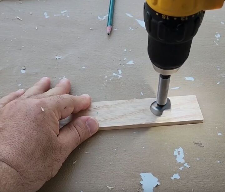Use a Forstner bit to carefully create holes in the wood strip