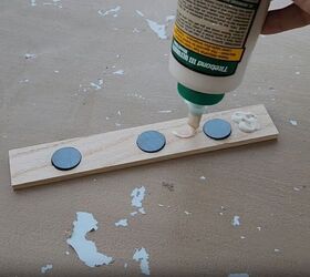 Place magnets in the holes and apply glue to the wood
