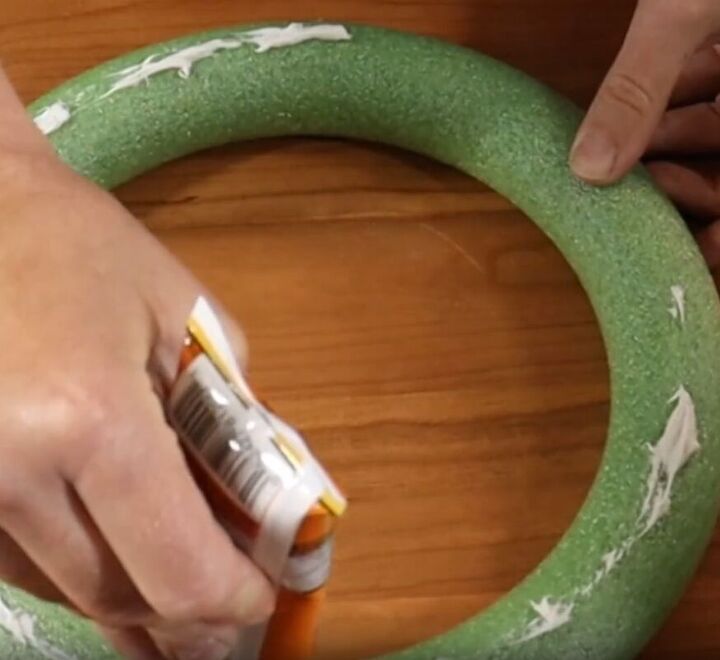 Spreading Gorilla construction adhesive on a foam ring