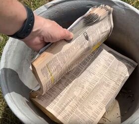 Old paper books can take up space at the bottom of a large plant pot