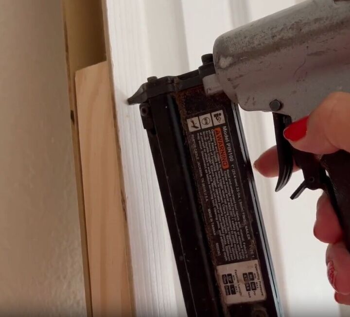 Securing one-by-twos to the inside of the door using a pin nailer