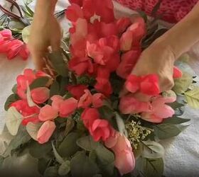 Arrange faux flowers to create a visually appealing composition