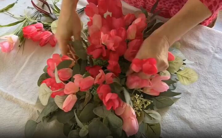 Arrange faux flowers to create a visually appealing composition
