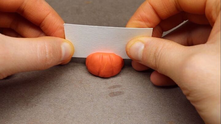 Pressing paper into the clay