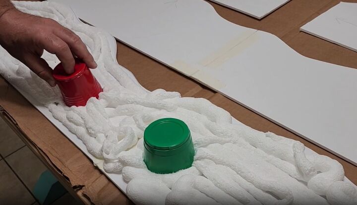 Adding gumdrops to the Gingerbread Door with multicolored cups