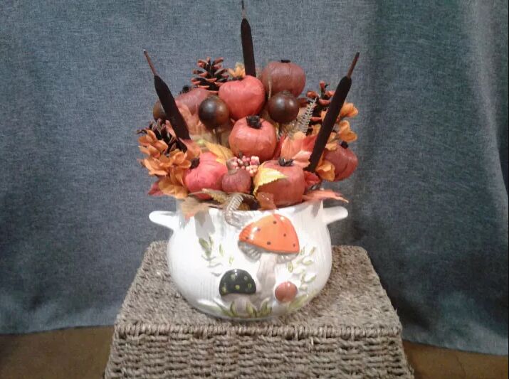 Floral arrangement with faux garlic bulbs and seed pods