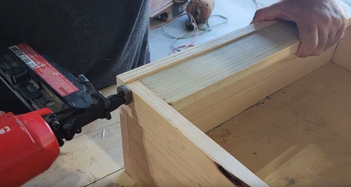 Nail the barrier piece to the inside of the shelf