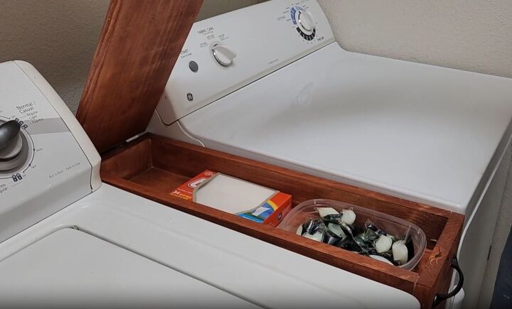 Organize laundry essentials with a hidden top shelf storage container