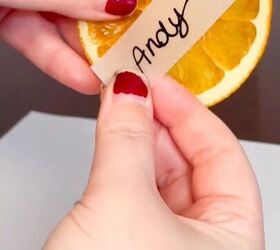 Attaching the place cards to the citrus slices