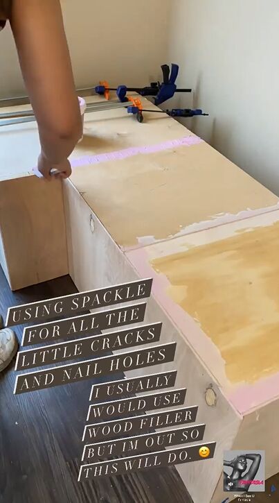 Applying spackle to the cracks and holes