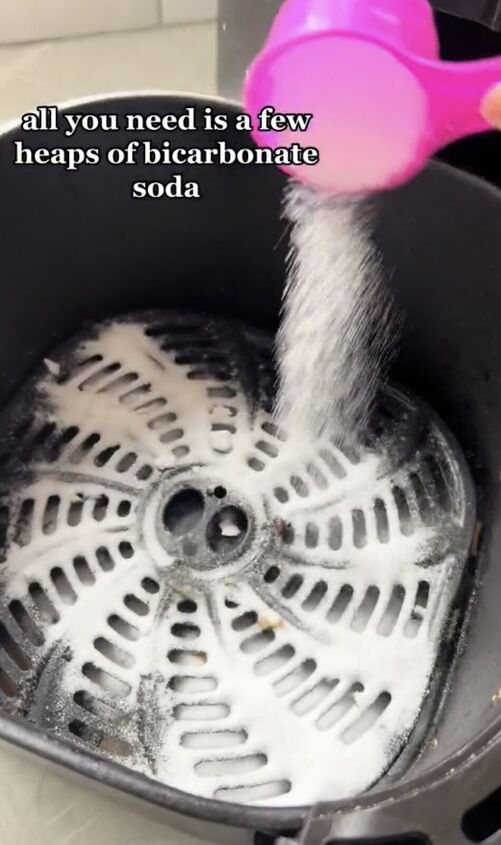 Pouring baking soda into the air fryer