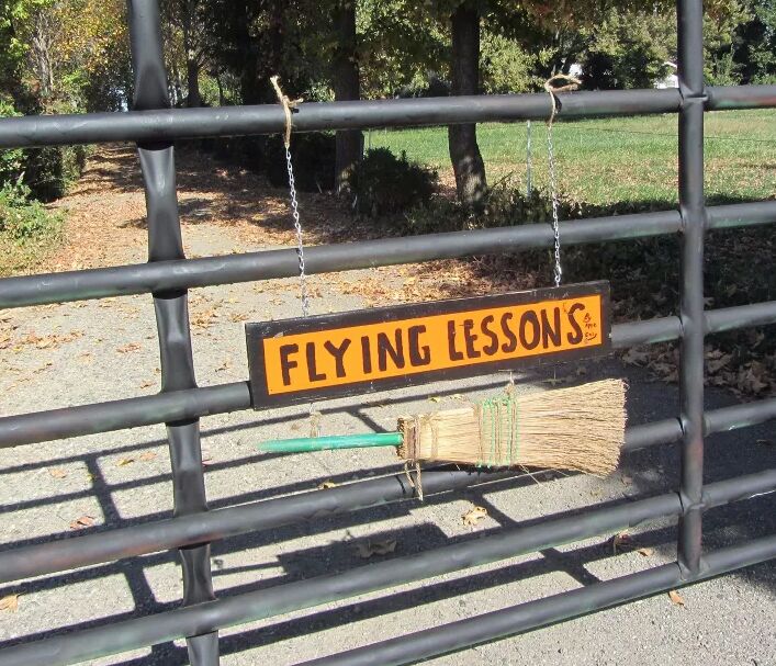 Flying lessons sign with a witch's broom