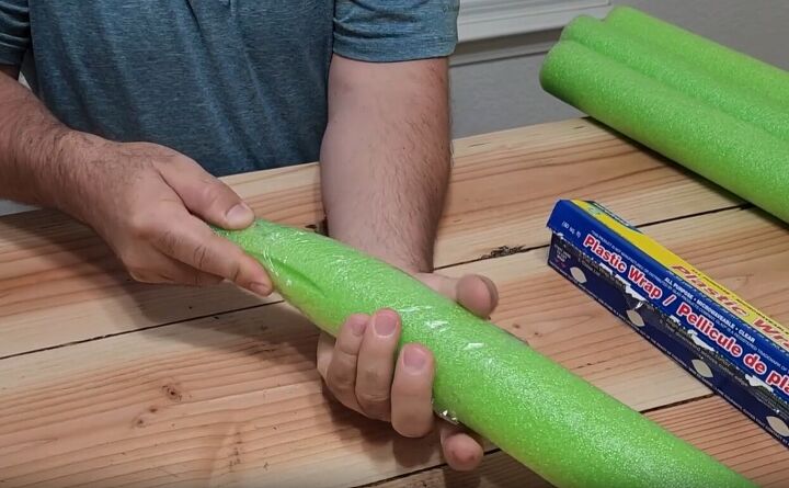Cover the end of the cut pool noodle with Saran wrap