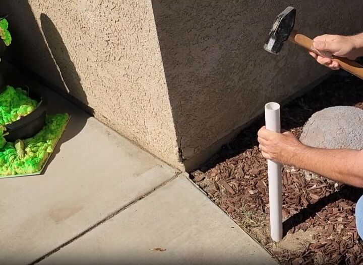 Drive the pipe into the ground as the base of your Halloween arch