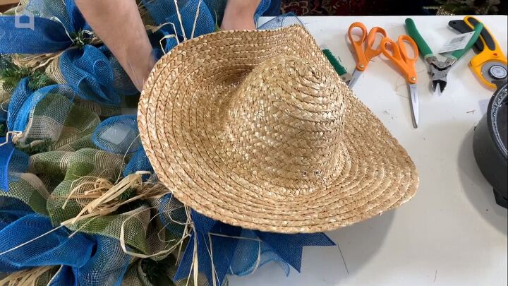 Attaching the straw hat to the wreath