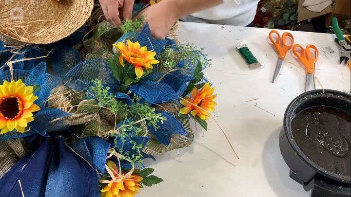 Adding greenery into the wreath