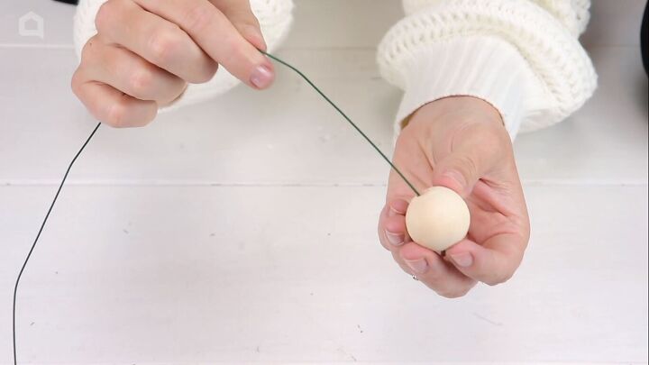 Inserting craft wire into a wooden bead