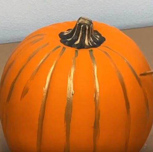 Apply gold paint to pumpkin