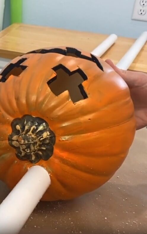 Insert the pvc pipes into the drilled holes in the pumpkins.