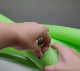 Peeling stickers off the pool noodles