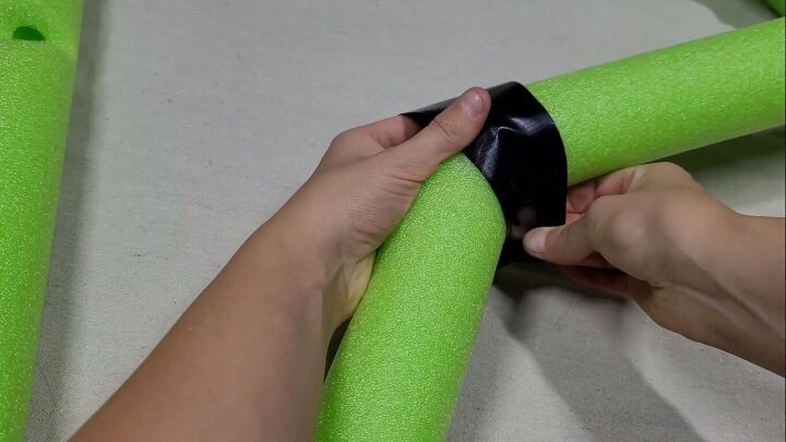 Bending the pool noodle and taping it