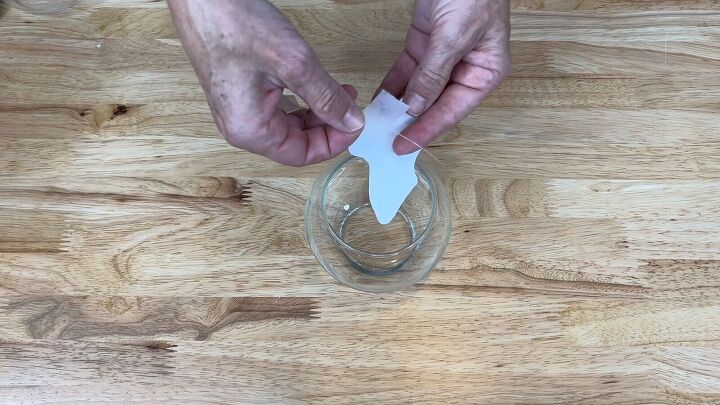 Stick a piece of fishing line to the back of the moth cut-out