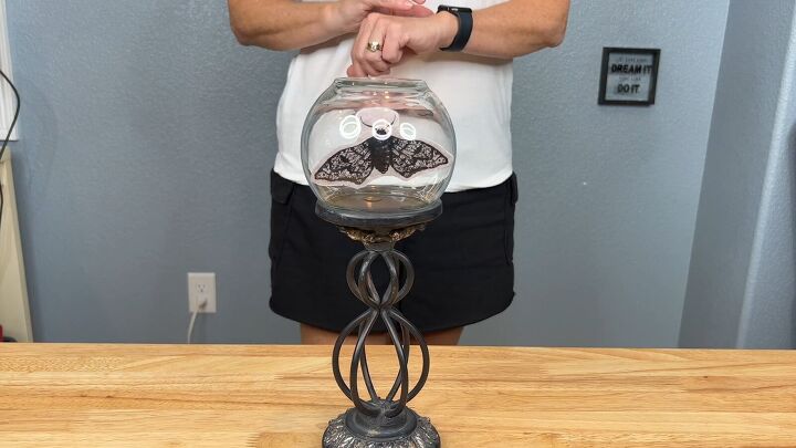 Place the bud vase on a candle holder