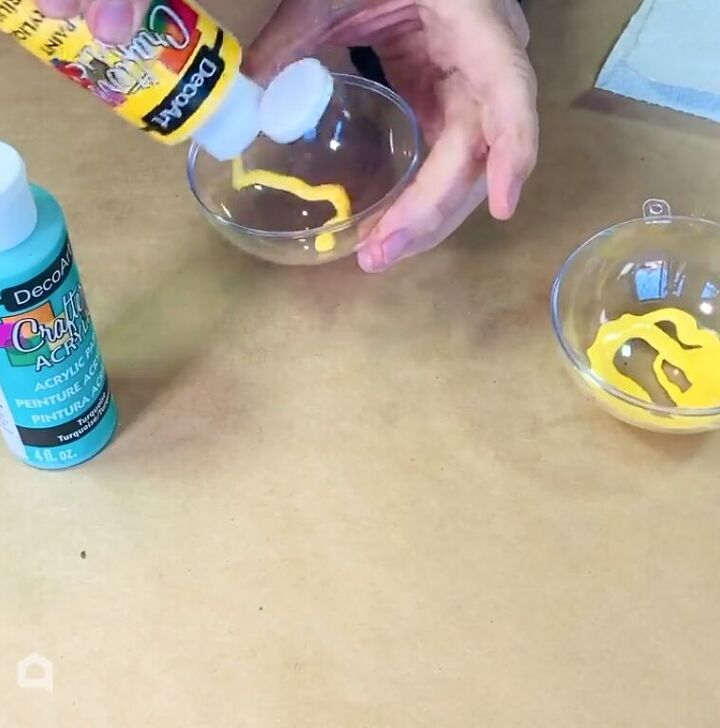 Pouring paint inside the ornament halves